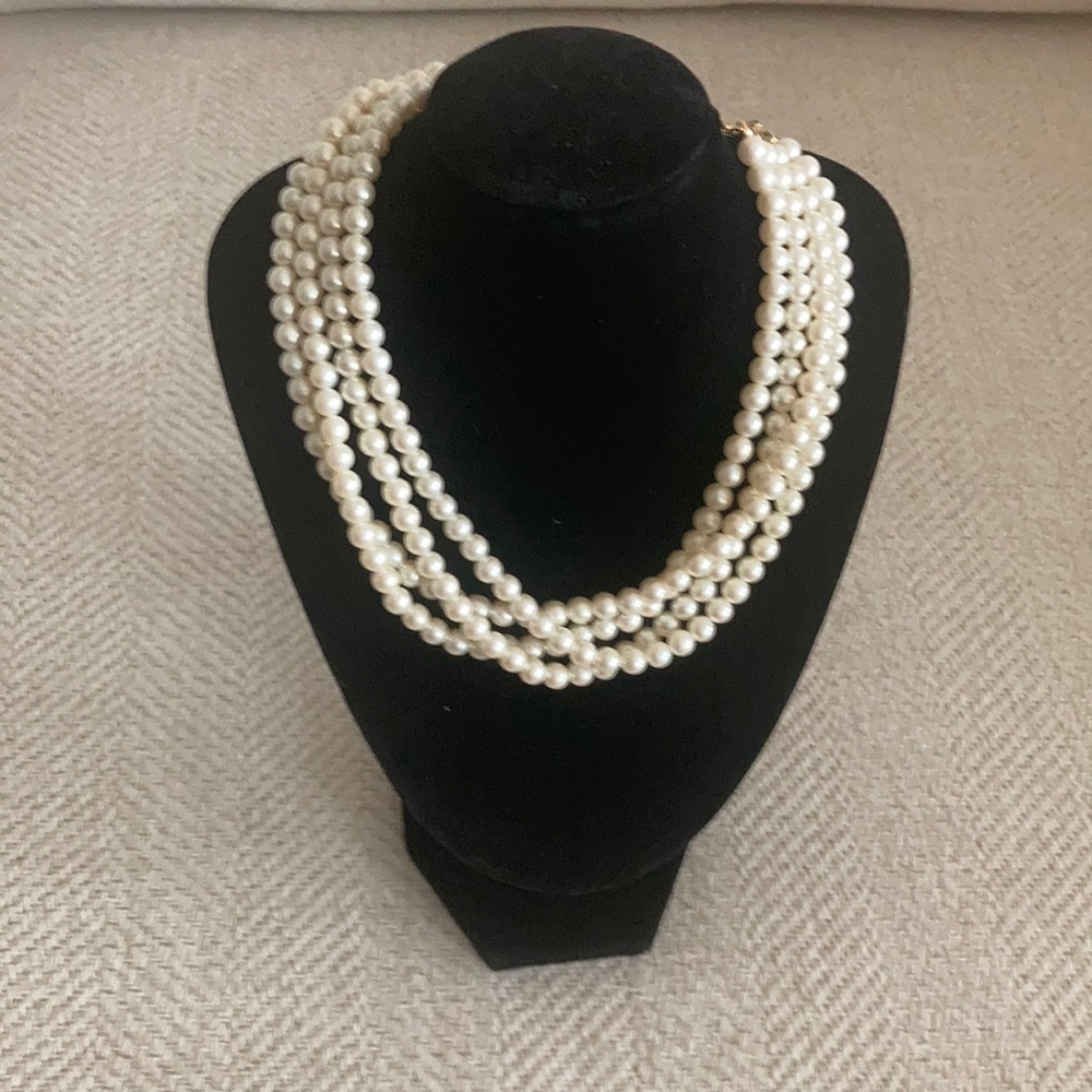 White costume pearls, 4 rows with gold tone closure.